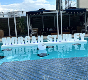 Custom floating foam pool letters in vibrant colors, spelling out a message on the water. Lightweight, durable, and perfect for pool parties, events and branding.